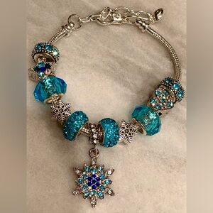 Turquoise Charm Bracelet with Silver Accents and a Snowflake in the middle.